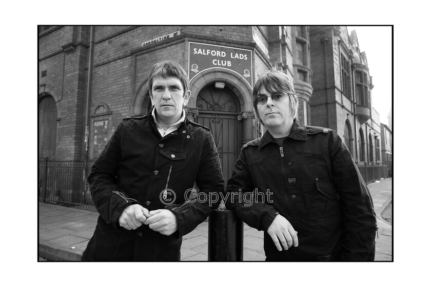 25D 
 UNITED KINGDOM - MARCH 01: Photo of Andy ROURKE and Mike JOYCE; Posed with Andy Rourke outside Salford Lad's Club L - R: Mike Joyce, Andy Rourke (Photo by Stephen Wright